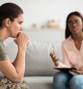 Black Psychologist Lady Making Therapy Session In Office With Depressed Female Soldier, Upset Woman In Military Uniform Sitting And Looking Away, Suffering Posttraumatic Stress Disorder, Closeup
